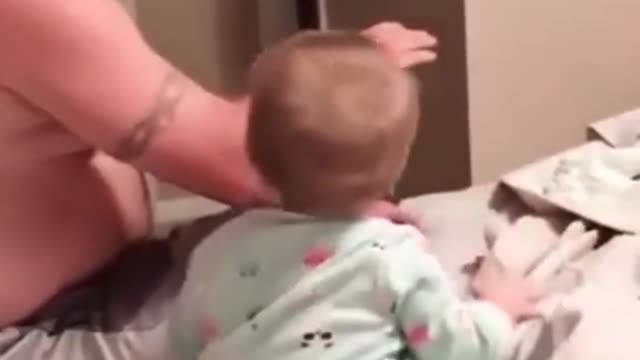 Happy baby is playing with dad and pretends to fallOVER.....