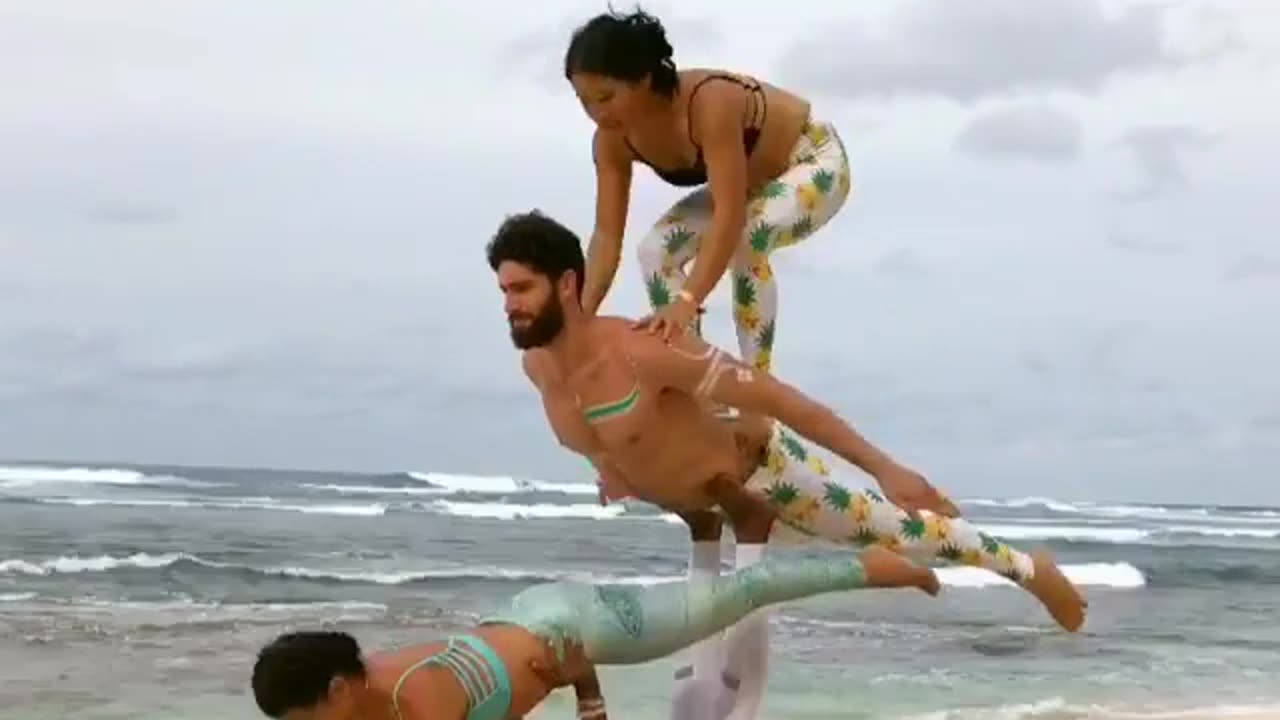 Group of Friends Do Acroyoga at the Beach