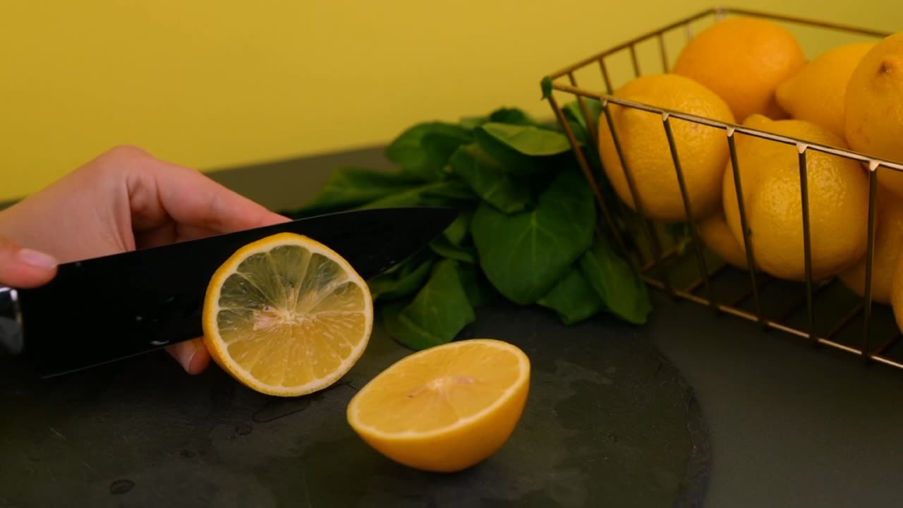 Person Slicing a Lemon