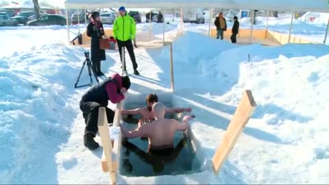 Russian swimmers play chess in freezing lake