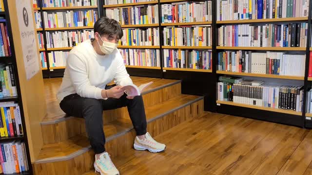 A man who reads at a bookstore.