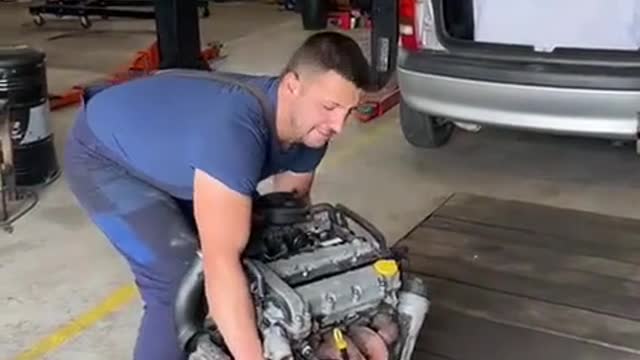 Car repairer installs car engine accessories