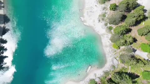 The turquoise surface of a charming mountain lake in Switzerland.