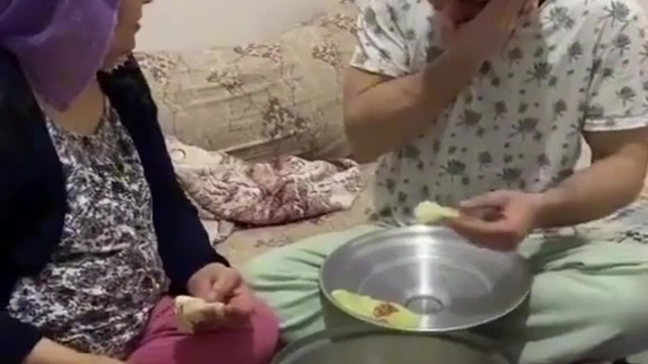 A son prepares food in the style of preparing a weed in front of his mother