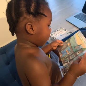 2 year old reads a book