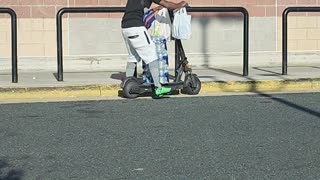 Man Precariously Stacks Bottles of Water on Scooter