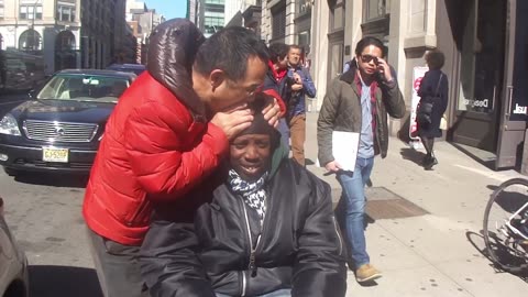 Luodong Massages Black Man On Sidewalk