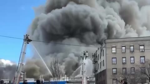 Multiple firefighters are battling a massive 5-alarm fire at Concourse Food Plaza in