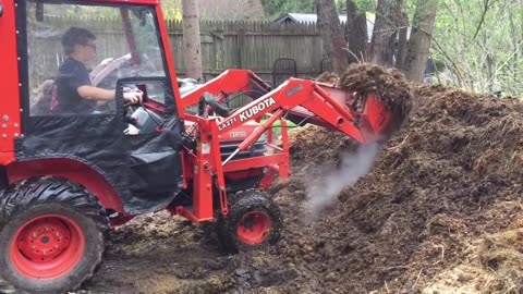 Daniel tossing the compost with Ted.