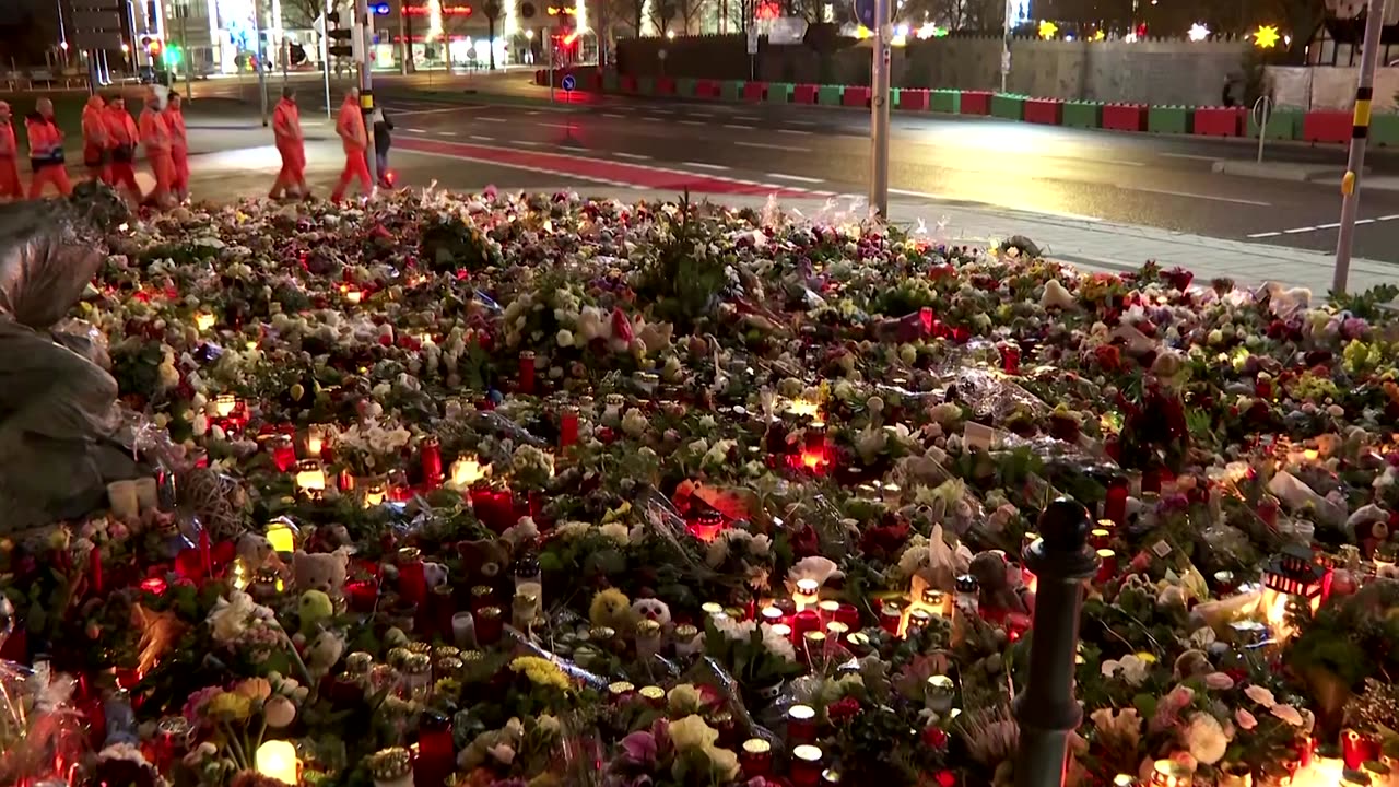 People lay flowers for victims of German Christmas market attack