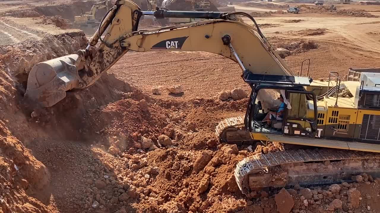 Caterpillar 365C Excavator Loading Trucks