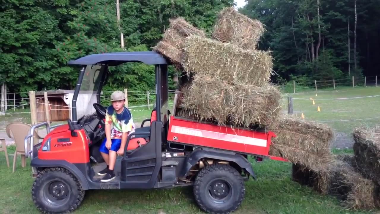 Daniel dumping the hay from the Kubota.