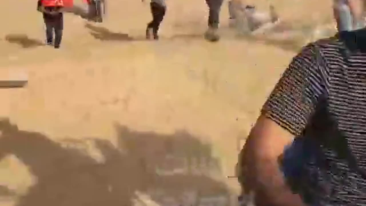 Palestinians attacking Israeli hostages captured by Hamas