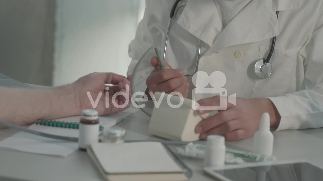 A Young Black Doctor Takes Blood Pressure To A Man