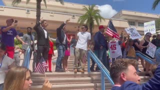 Jack Posobiec leads the crowd in chants of “USA” as protestors leave TPUSA’s Student Action Summit