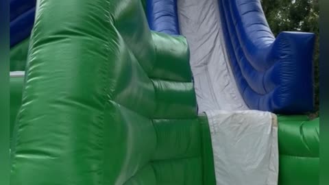 Kid Accidentally Front Flips Down Bouncy Slide