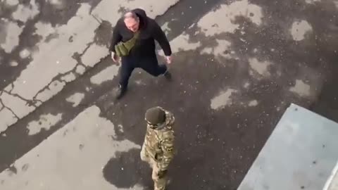 A Ukrainian civilian attacks and chases away a Ukrainian conscription officer