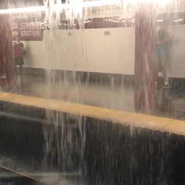 Water rushing into subway rail tracks