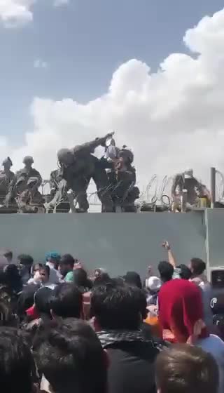 Jaw Dropping Video Shows Toddler Getting Lifted Over Kabul Airport Wall