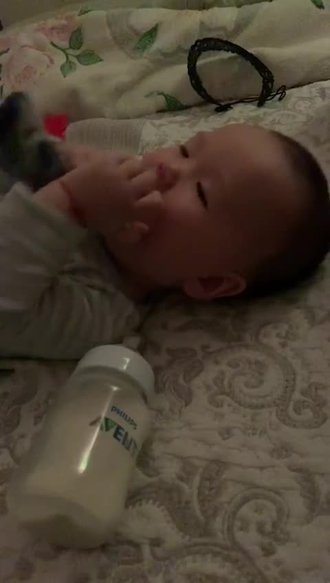 Baby boy is sucking a sock