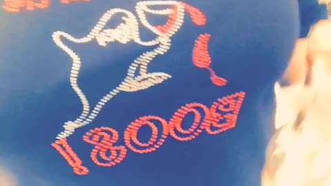 Music girl in black shirt poses next to bottle of alcohol