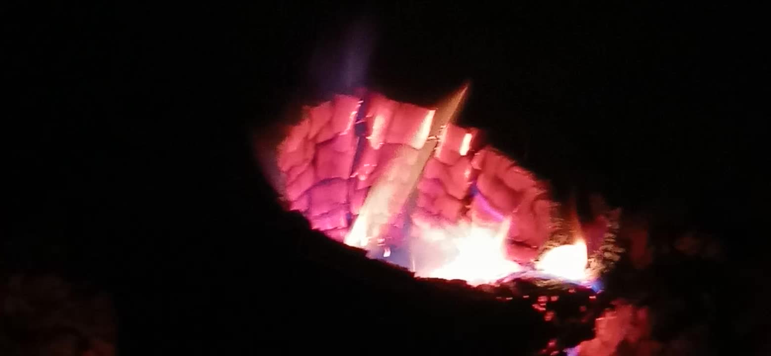 A Wood Stove Burning A Holey Oak Log