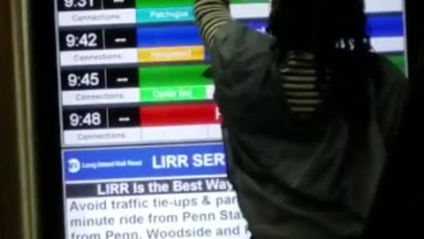 Woman rubs white phone along a screen in subway staion