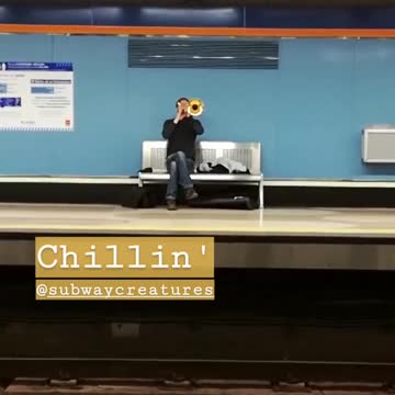 Guy playing trumpet in subway chillin