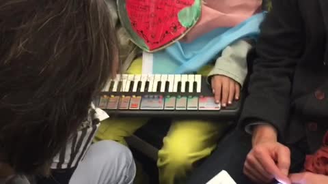 Guy dresses as fox on subway playing piano with strawberry necklace