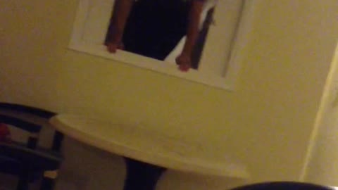Guy jumps through kitchen window unto table