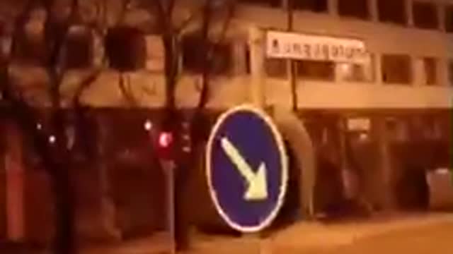 Drunk guy runs his head into blue arrow sign and falls down