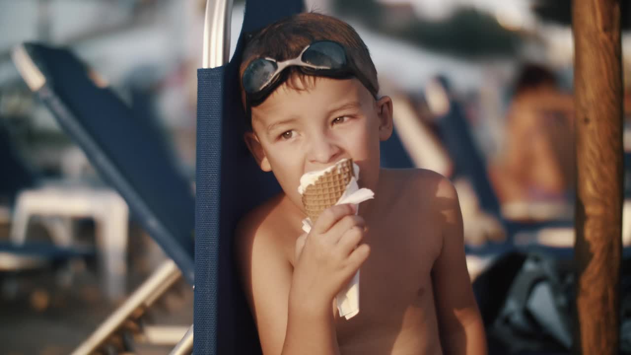 Boy eating an ice cream while looking away