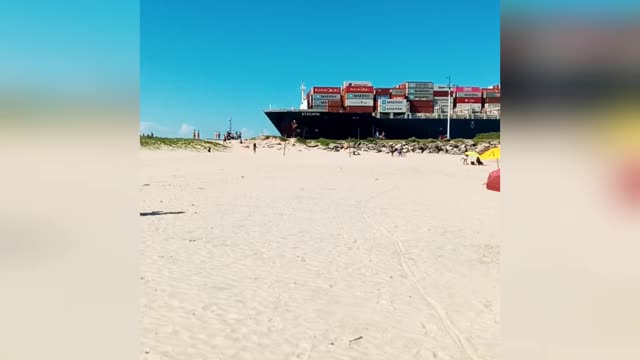 Huge cargo ship invades beach detours at the last minute