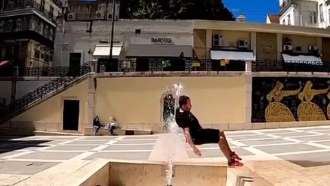 dude fails miserably attempting flying somersault over water fountain