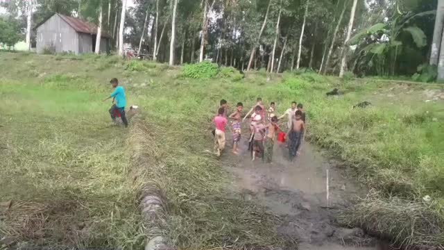 village boys catch fish in Bangladesh