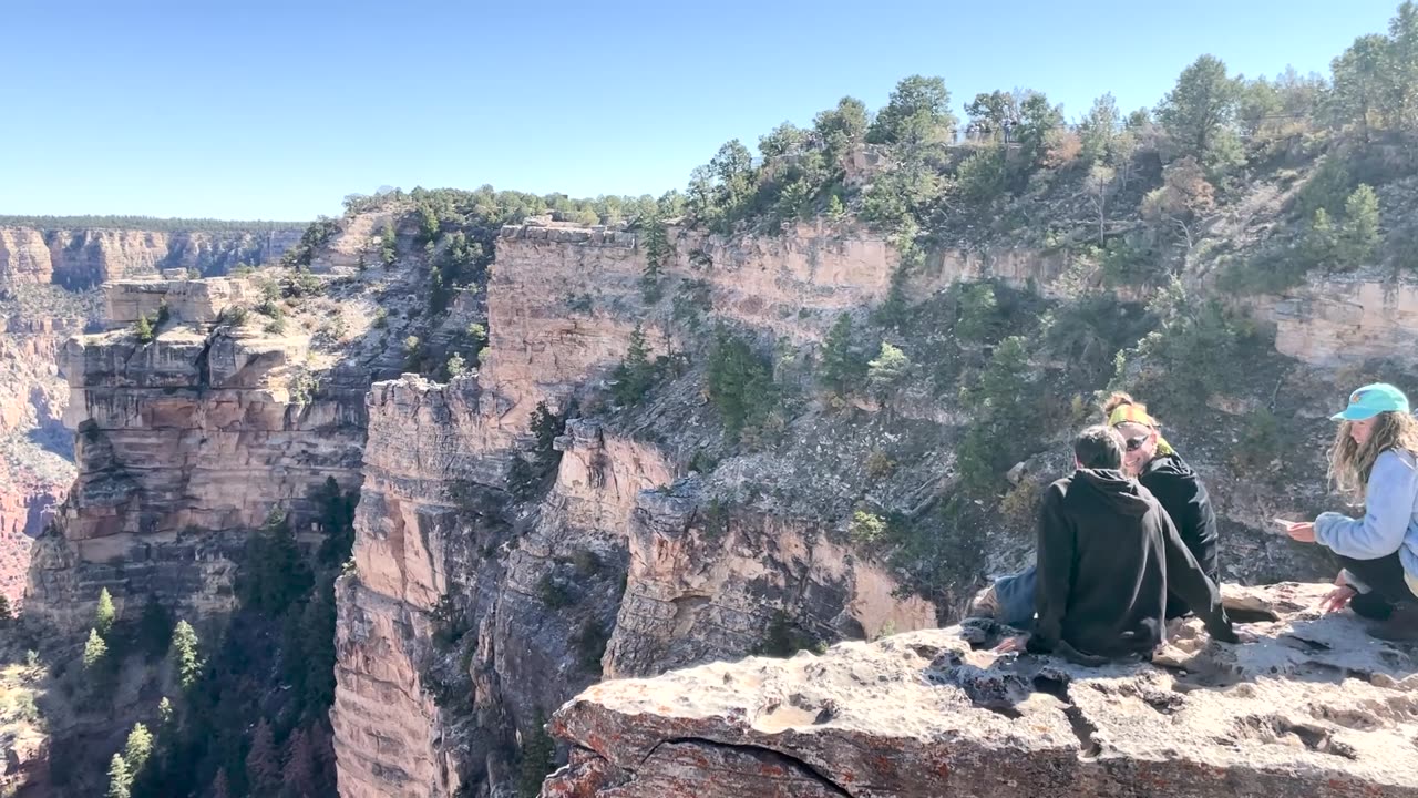 Tourists Hop Over Railing at Grand Canyon