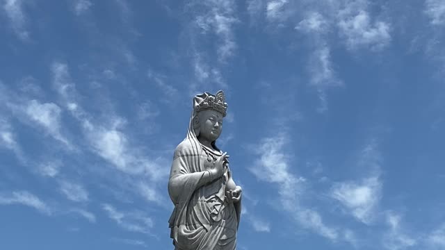 Buddha statue located high up in the sky