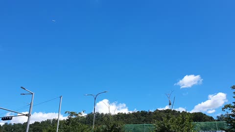 an airplane flying in the blue sky