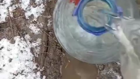 Russian Soldier Fishing Water Out of a Dirty Puddle