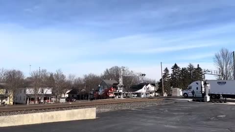 Truck Driver Tries to Beat a Train at a Railroad Crossing