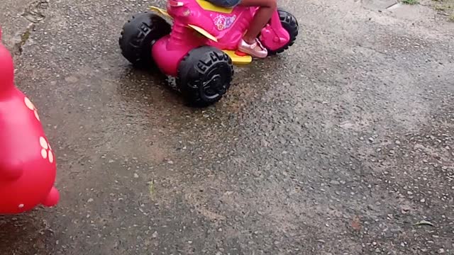 my daughter riding a velotrol