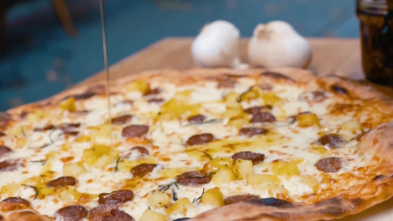 Pouring oil on delicious pizza - 4K UHD