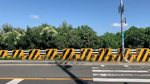 peaceful road, car passing on a sunny day