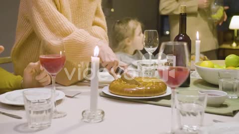 Close Up Of A Woman Cutting Pie During A Dinner With Her Family