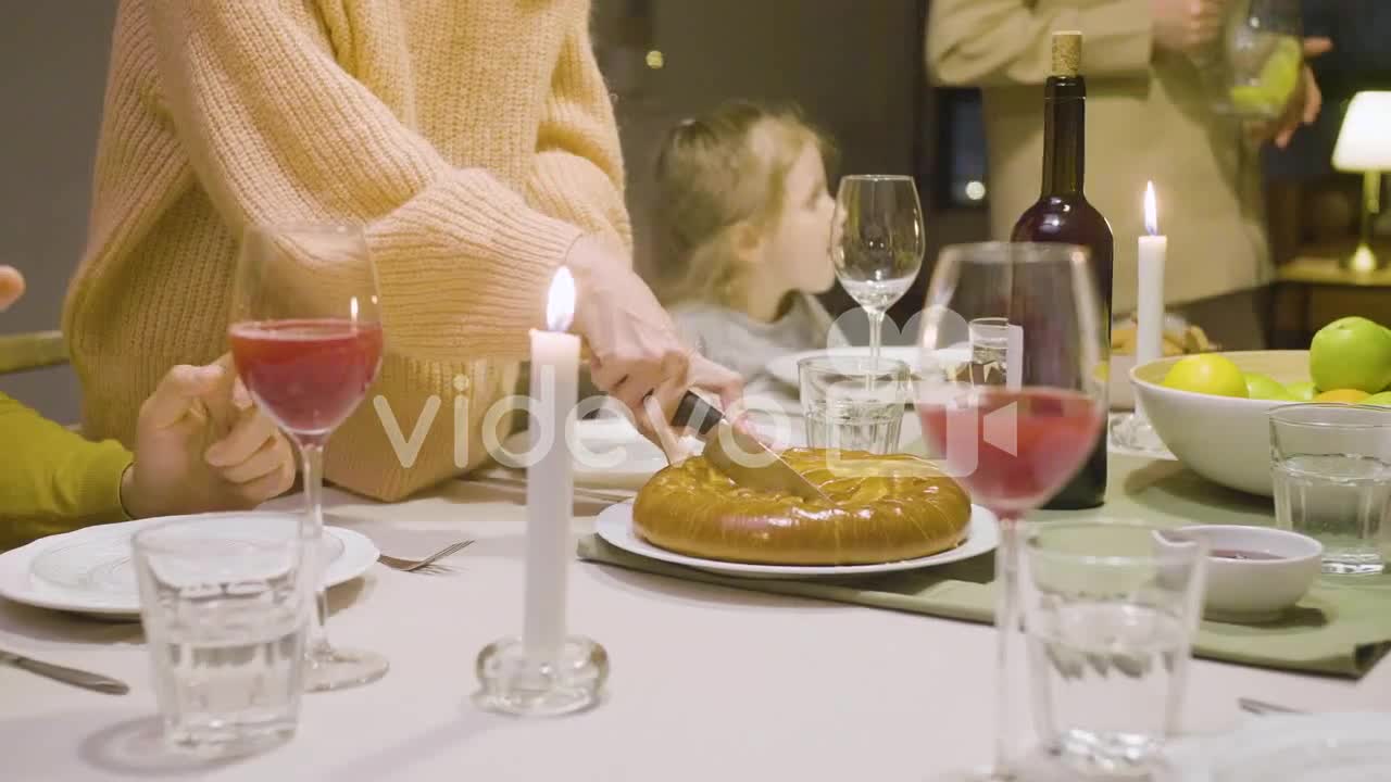 Close Up Of A Woman Cutting Pie During A Dinner With Her Family