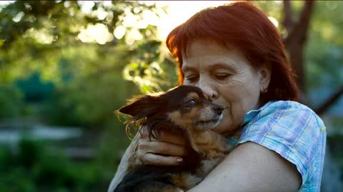 Happy lady caresses her little dog