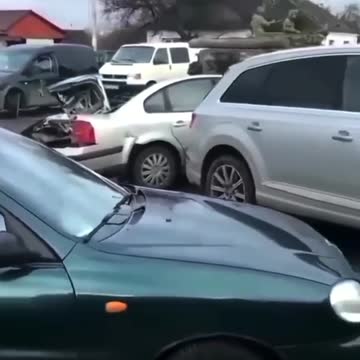 Tanks rolling through Ukraine, crushing cars in the way