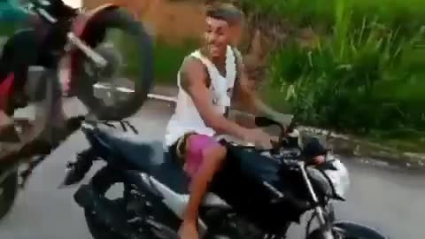 young man pays no attention and ends up hitting his friend with his motorcycle