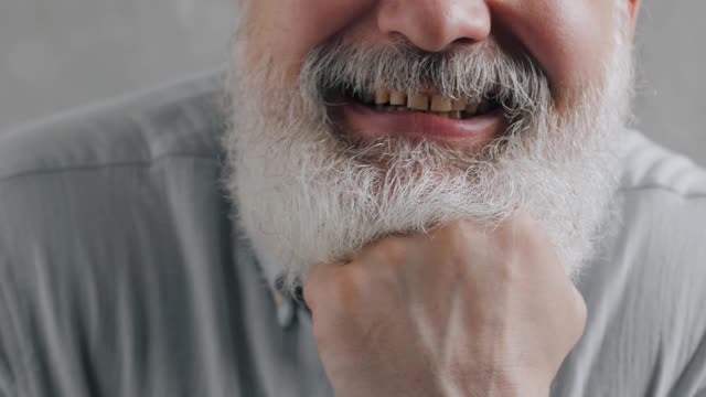 older man playing with his tongue