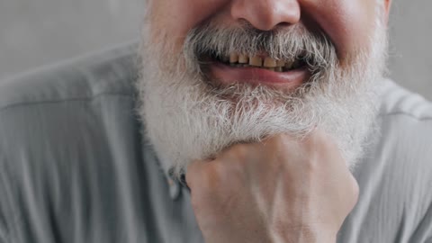 older man playing with his tongue